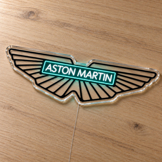 Aston Martin F1 LED Neon Sign, featuring team logo displayed on a wooden surface.