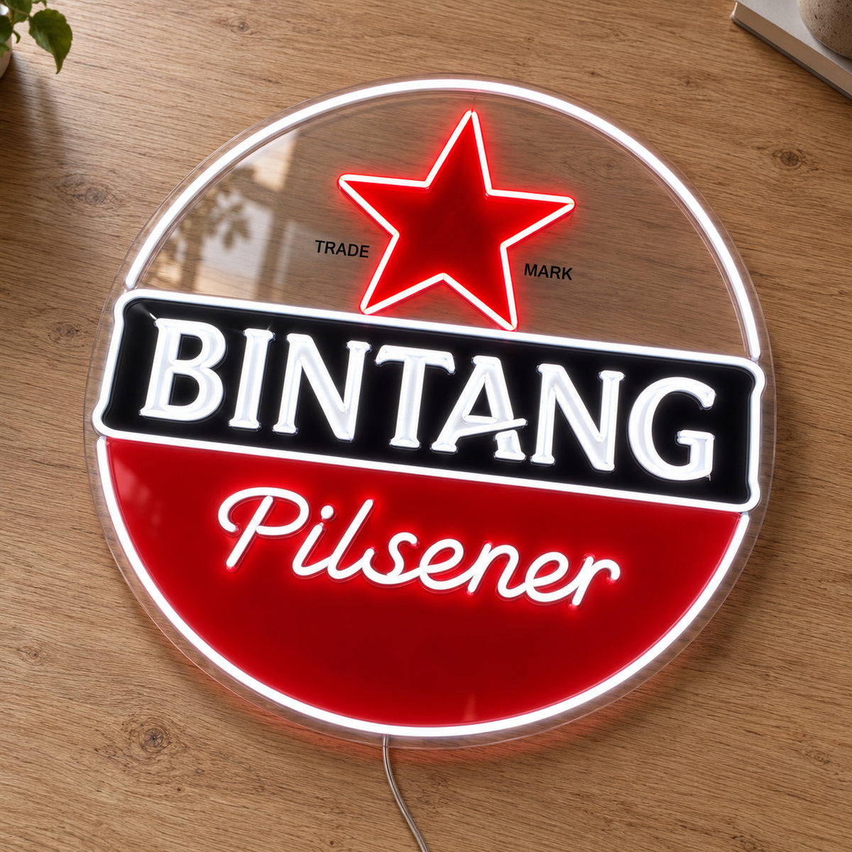 Bintang Pilsener LED Neon Sign, featuring beer-brand logo displayed on a wooden surface.