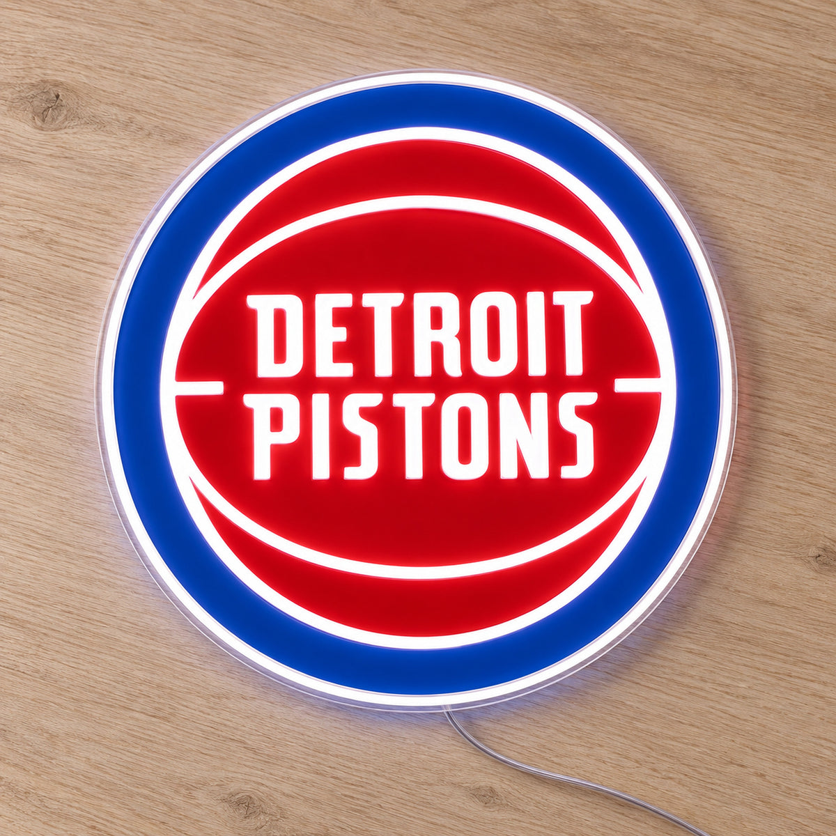 Detroit Pistons LED Neon Sign, featuring illuminated team logo on a wooden surface.