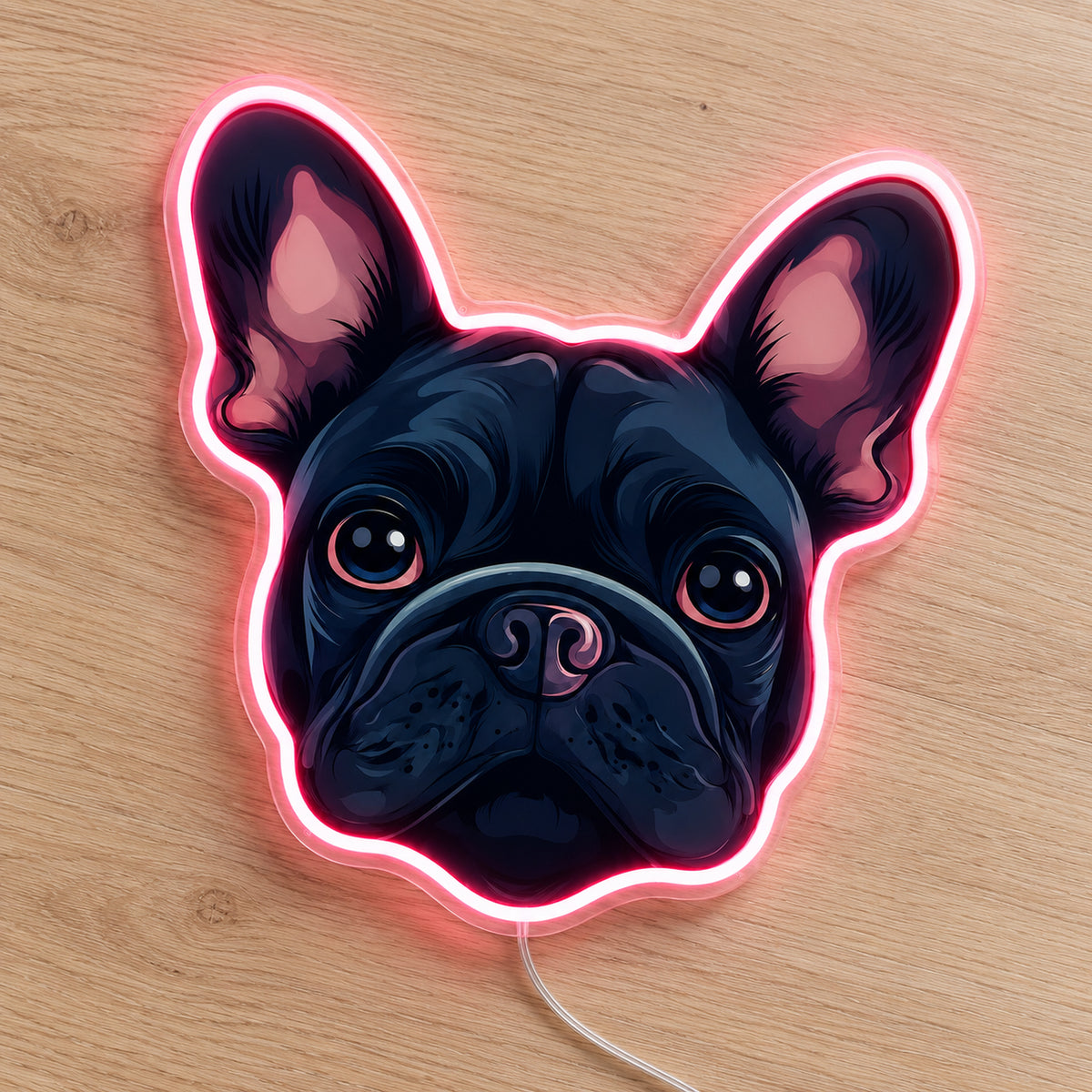 French Bulldog LED Neon Sign in pink, featuring a French bulldog face with a glowing outline on a wooden surface.