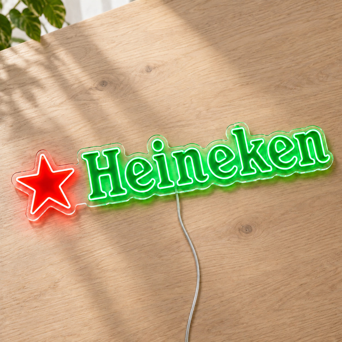 Heineken LED Neon Sign, featuring beer-brand logo displayed on a wooden surface.