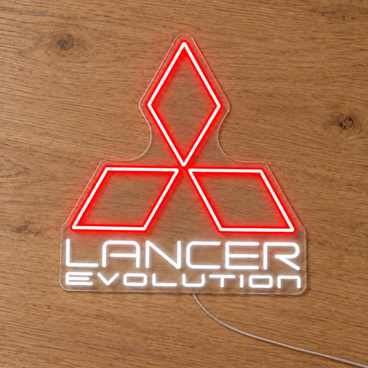 Lancer Evolution Logo LED Neon Sign in red and white, featuring Mitsubishi emblem above Lancer Evolution lettering on a wooden surface.