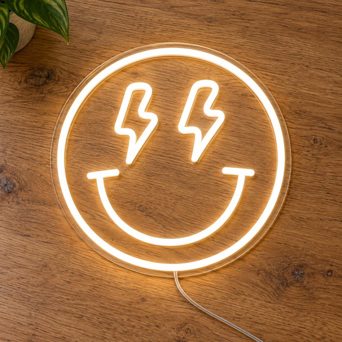 Lightning Smiley Face LED Neon Light Sign in warm white, featuring smiley-face outline with lightning-bolt eyes on a wooden surface.