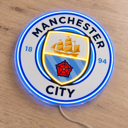 Manchester City LED Neon Sign, featuring illuminated team logo on a wooden surface.