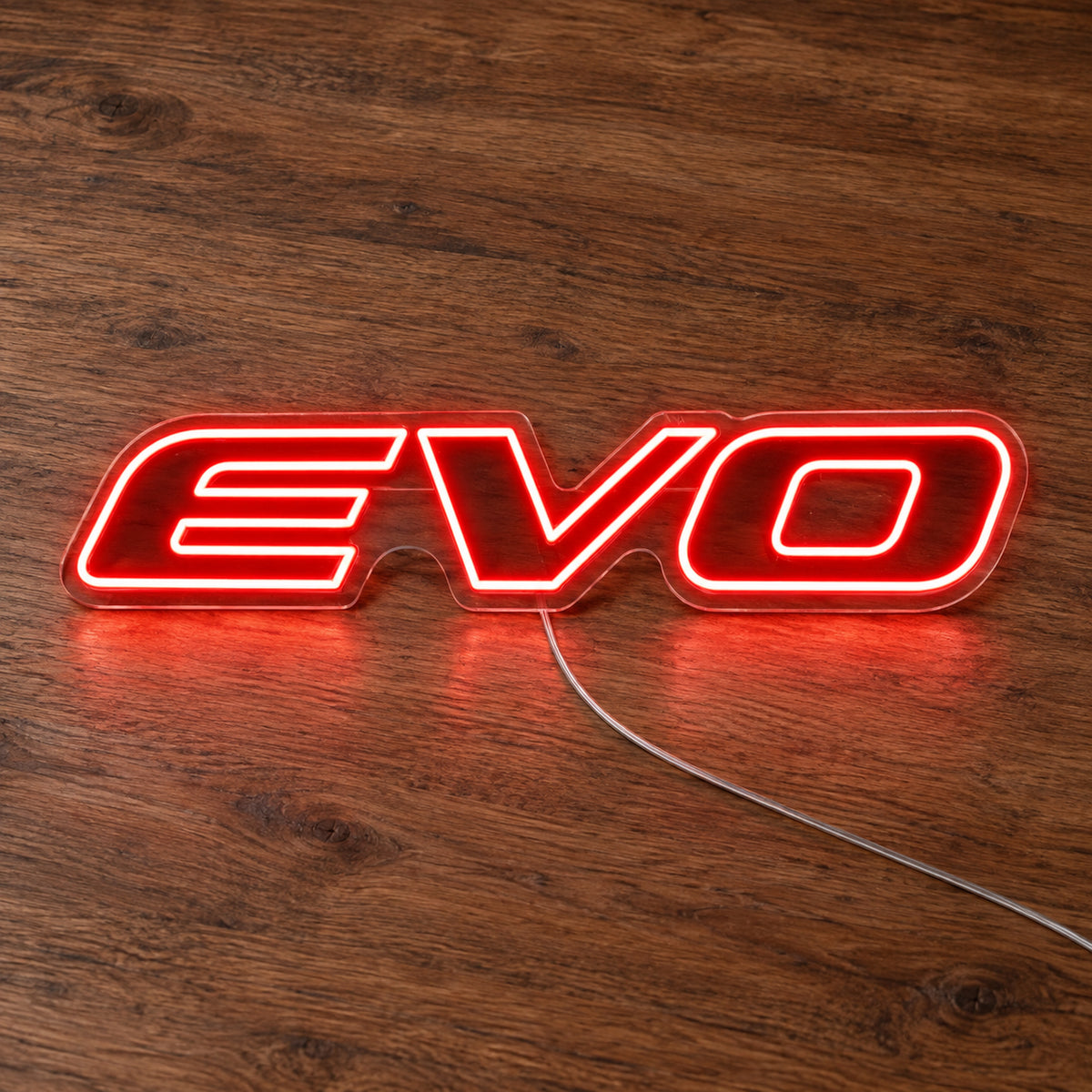 Mitsubishi Evo Logo LED Neon Sign in red, featuring Evo lettering on a wooden surface.