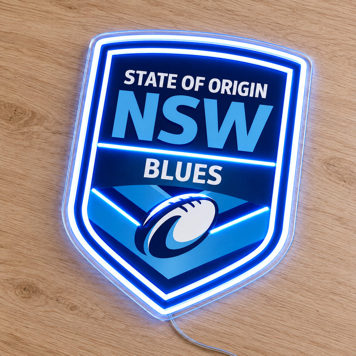 NSW Blues (State of Origin) LED Neon Sign, featuring illuminated team logo on a wooden surface.