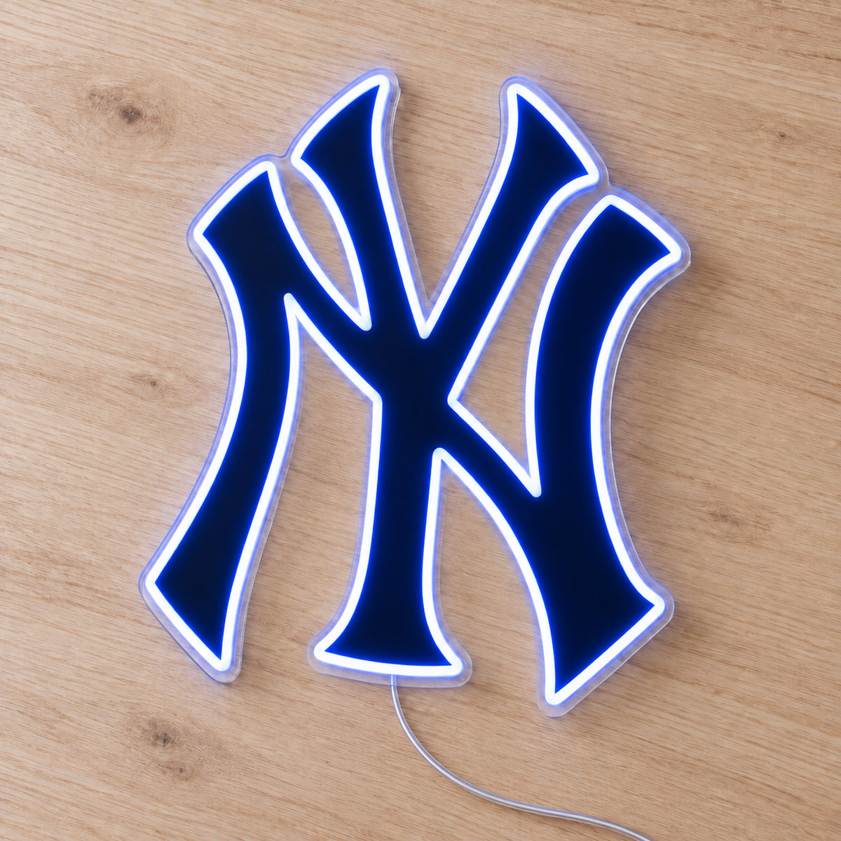 New York Yankees LED Neon Sign, featuring team logo displayed on a wooden surface.