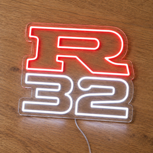 Nissan R32 LED Neon Sign in red and white, featuring R32 lettering on a wooden surface.