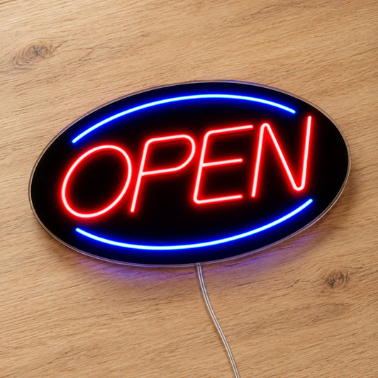 Open Neon Sign - Classic LED Business Sign in red and blue, featuring Open lettering inside an oval border on a wooden surface.
