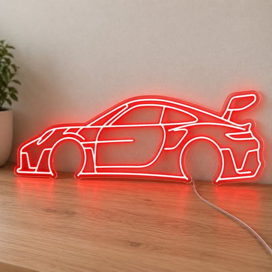 Porsche 911 LED Neon Sign in red, featuring a Porsche 911 car outline on a wooden surface.