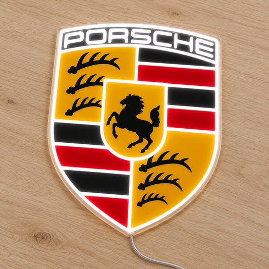 Porsche Crest LED Neon Sign, featuring vehicle-brand emblem displayed on a wooden surface.