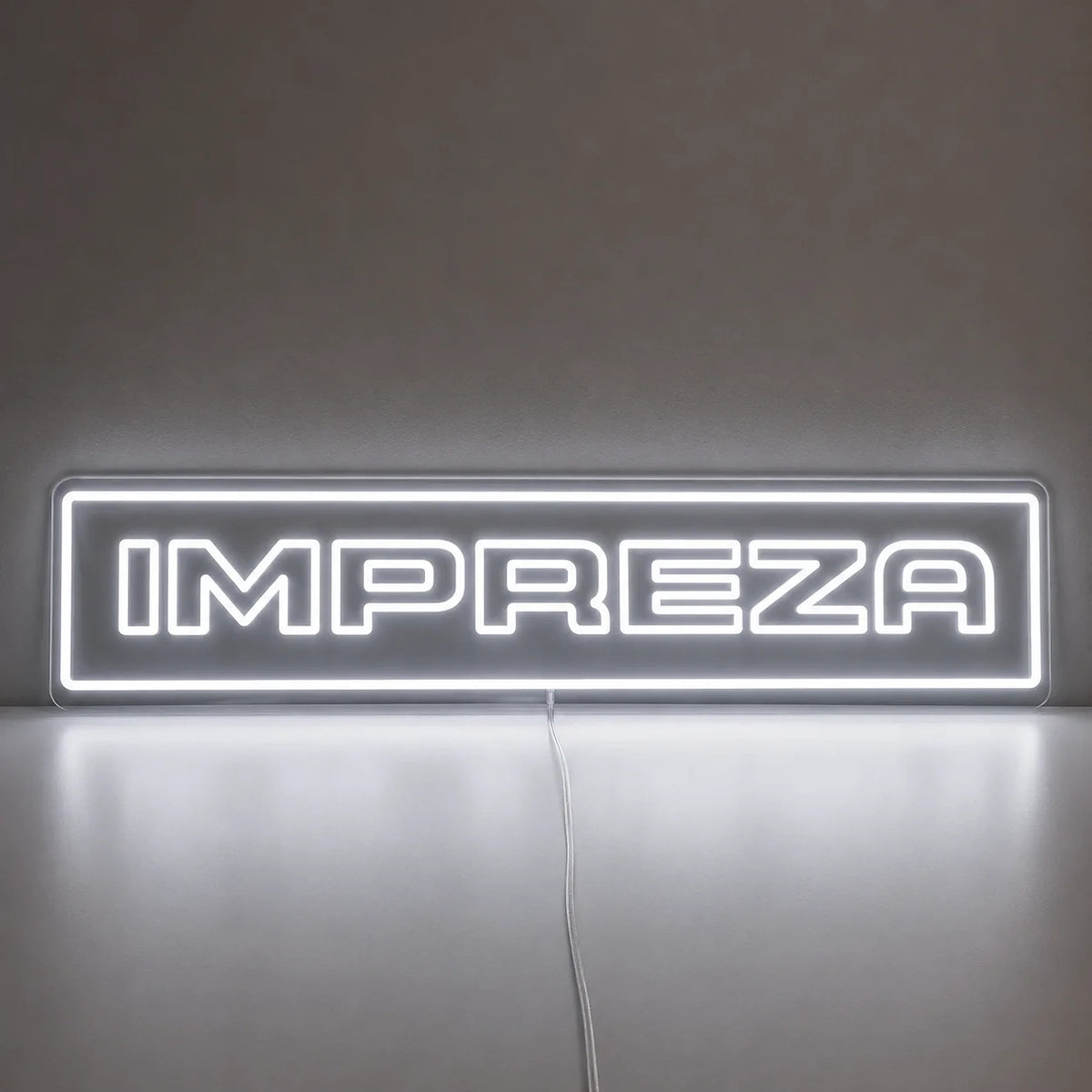 Subaru Impreza WRX Neon Sign in white, featuring Impreza lettering inside a rectangular border on a reflective surface.