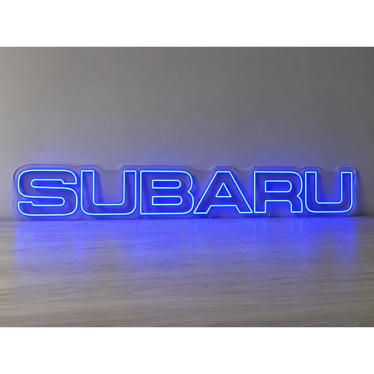 Subaru Logo LED Neon Sign in blue, featuring Subaru lettering on a light surface.
