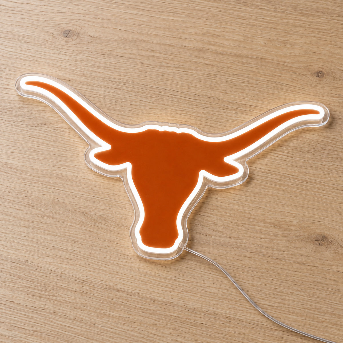 Texas Longhorns LED Neon Sign, featuring illuminated team logo on a wooden surface.