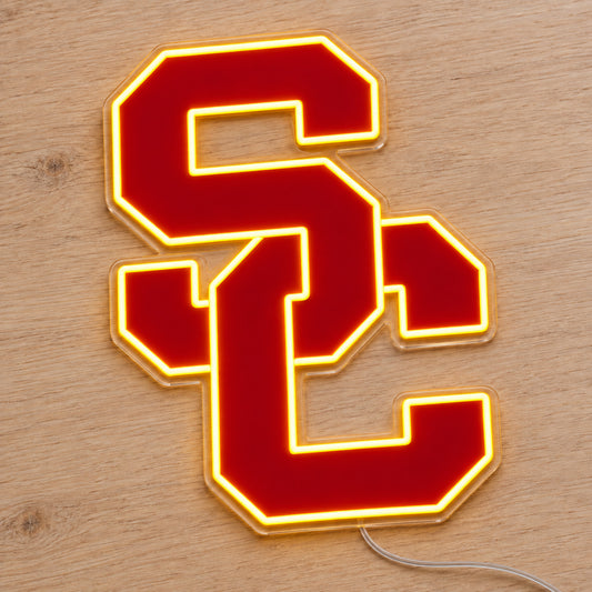 USC Trojans LED Neon Sign, featuring team logo displayed on a wooden surface.