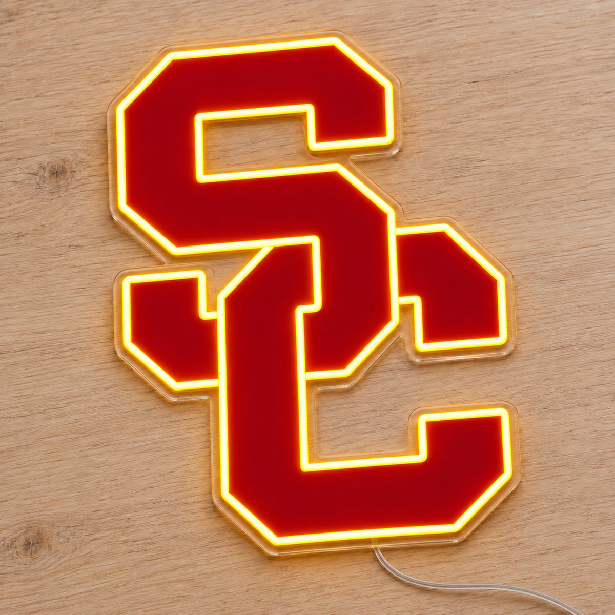 USC Trojans LED Neon Sign, featuring team logo displayed on a wooden surface.