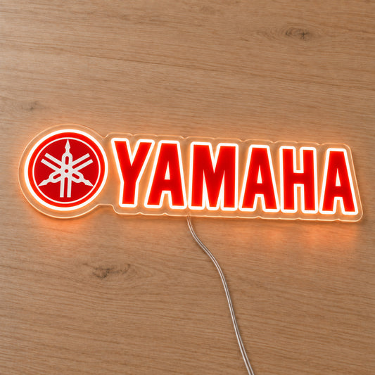 Yamaha (Emblem Logo) LED Neon Sign, featuring illuminated vehicle logo on a wooden surface.