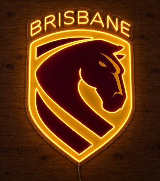 Brisbane Broncos Neon Sign, featuring illuminated team logo on a wooden surface in dim lighting.