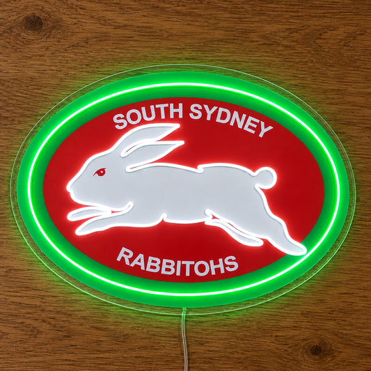 South Sydney Rabbitohs Neon Sign, featuring illuminated team logo on a wooden surface.