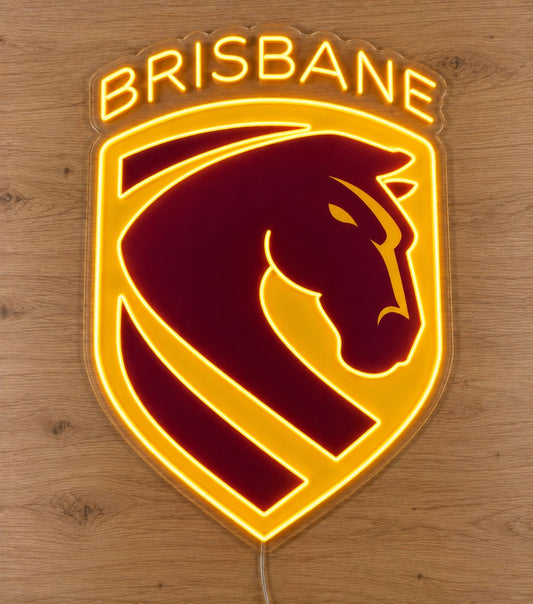 Brisbane Broncos Neon Sign, featuring illuminated team logo on a wooden surface.