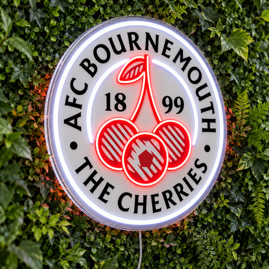 AFC Bournemouth LED Neon Sign, featuring team logo displayed on a green foliage wall.
