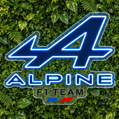 Alpine F1 LED Neon Sign, featuring team logo displayed on a green foliage wall.