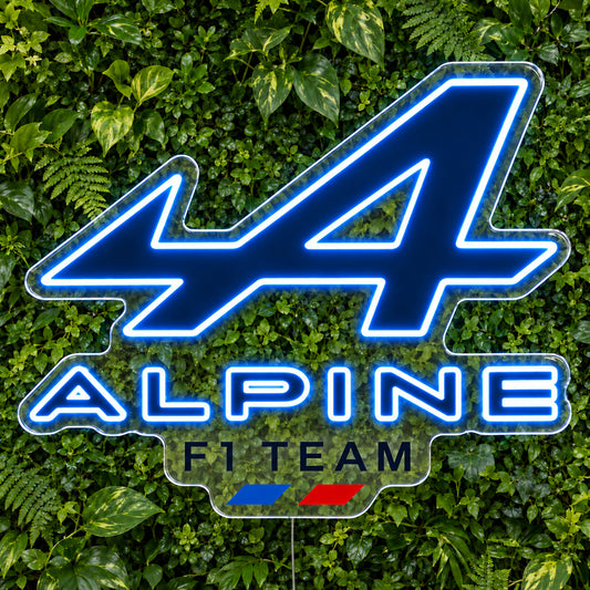 Alpine F1 LED Neon Sign, featuring team logo displayed on a green foliage wall.