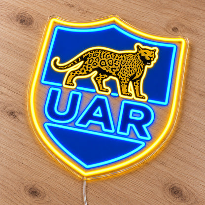 Argentina Rugby LED Neon Sign, featuring team logo displayed on a wooden surface.