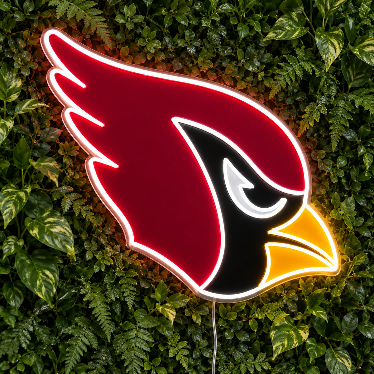 Arizona Cardinals LED Neon Sign, featuring team logo displayed on a green foliage wall.