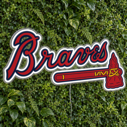 Atlanta Braves LED Neon Sign, featuring illuminated team logo on a green foliage wall.