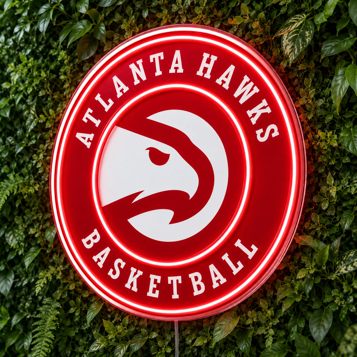 Atlanta Hawks LED Neon Sign, featuring illuminated team logo on a green foliage wall.