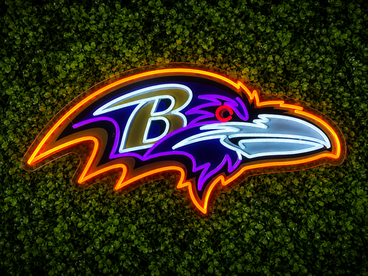 Baltimore Ravens LED Neon Sign, featuring illuminated team logo on a green foliage wall.