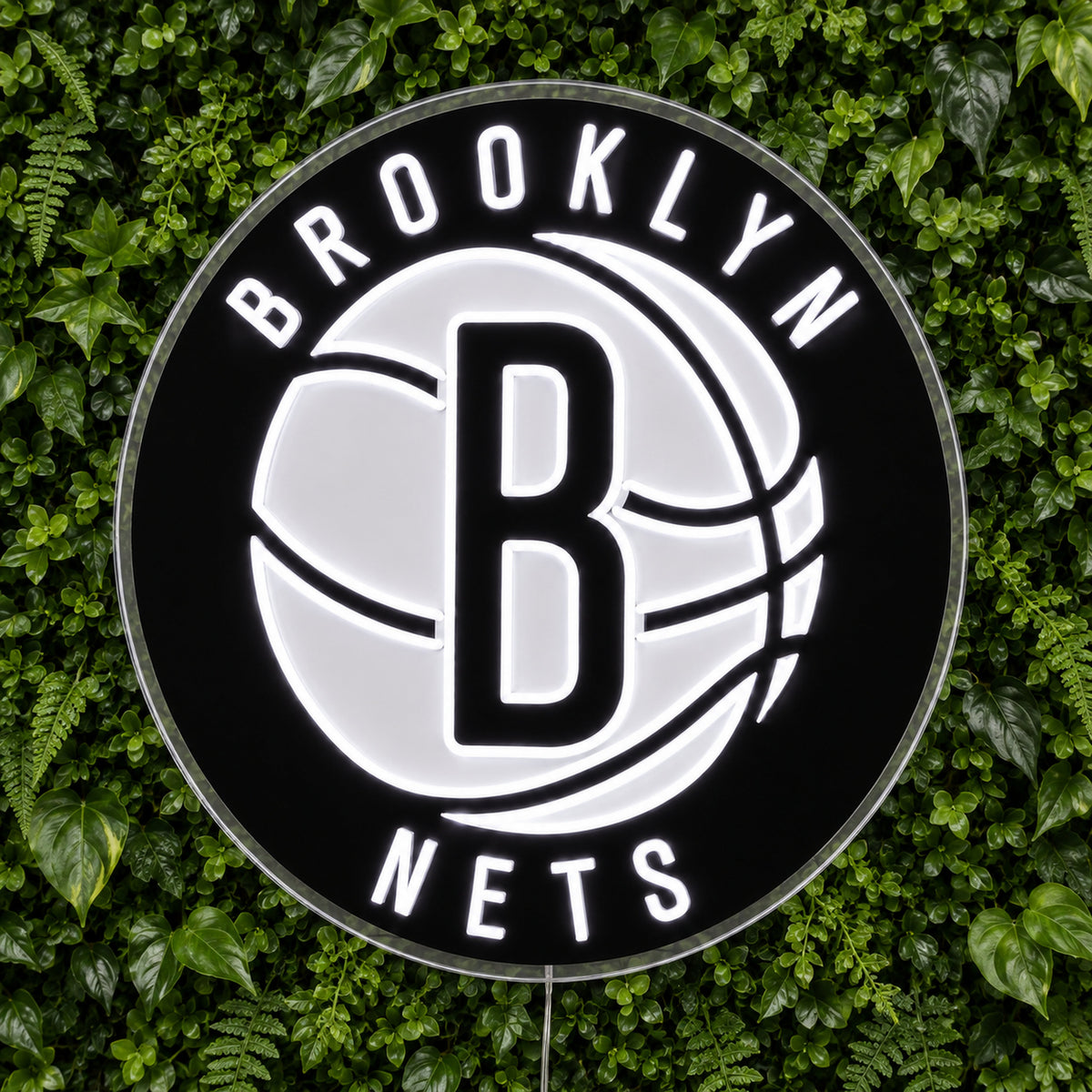 Brooklyn Nets LED Neon Sign, featuring illuminated team logo on a green foliage wall.