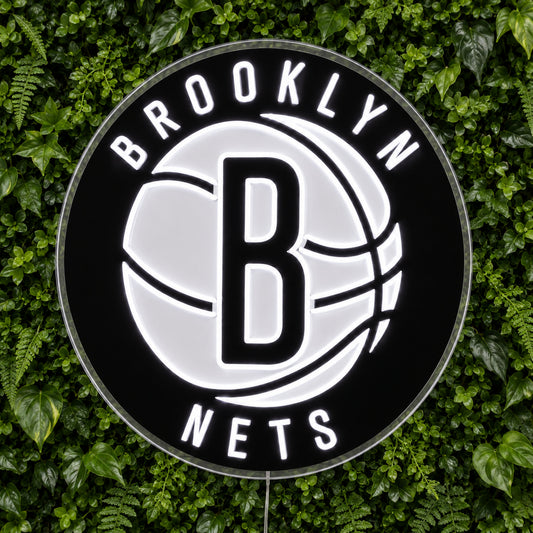 Brooklyn Nets LED Neon Sign, featuring illuminated team logo on a green foliage wall.