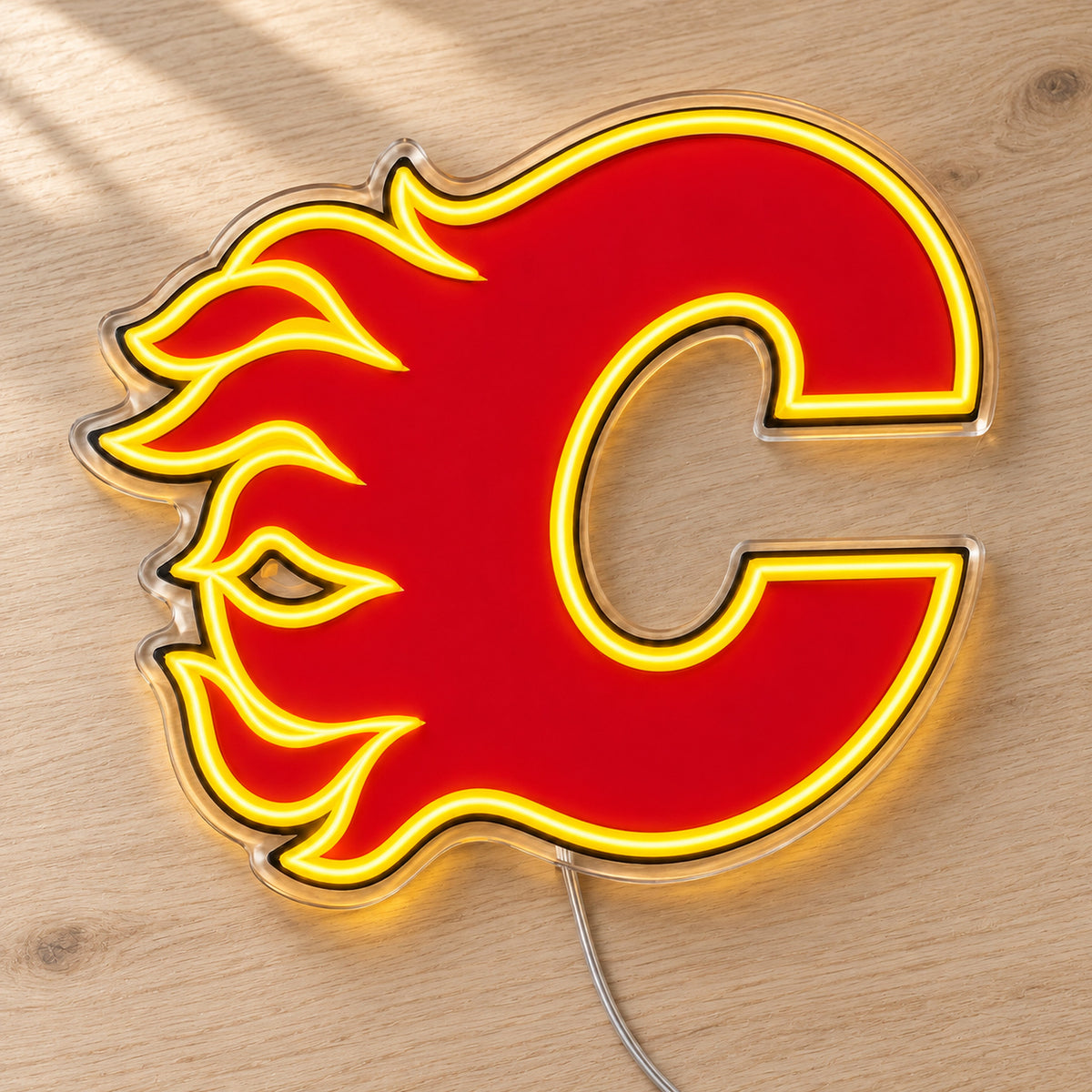 Calgary Flames LED Neon Sign, featuring team logo displayed on a wooden surface.