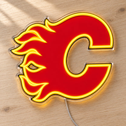 Calgary Flames LED Neon Sign, featuring team logo displayed on a wooden surface.