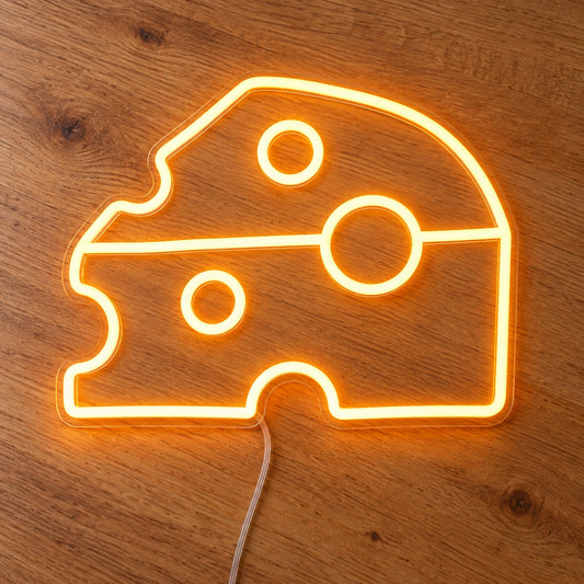 Cheese Block LED Neon Light Sign in yellow, featuring cheese-wedge outline on a wooden surface.