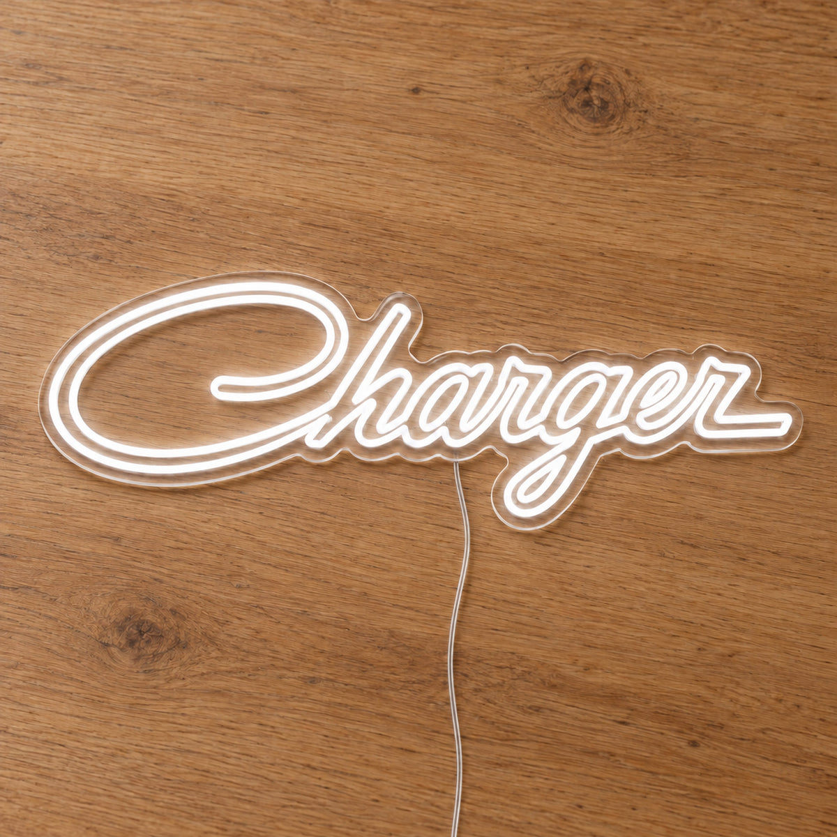 Chrysler Charger LED Neon Sign in warm white, featuring Charger script lettering on a wooden surface.