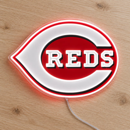 Cincinnati Reds LED Neon Sign, featuring illuminated team logo on a wooden surface.