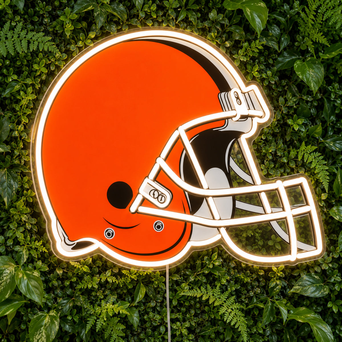 Cleveland Browns LED Neon Sign, featuring illuminated team logo on a green foliage wall.