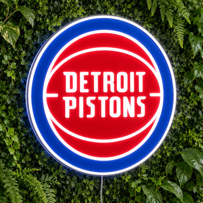 Detroit Pistons LED Neon Sign, featuring illuminated team logo on a green foliage wall.