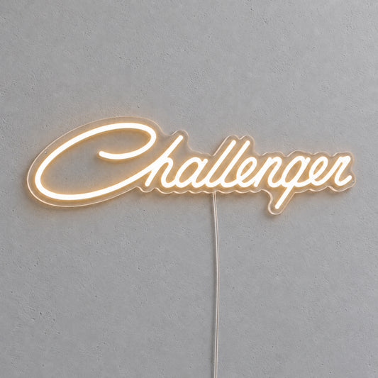 Dodge Challenger LED Neon Sign in warm white, featuring Challenger script lettering on a grey wall.