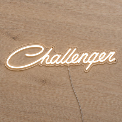Dodge Challenger LED Neon Sign in warm white, featuring Challenger script lettering on a wooden surface.