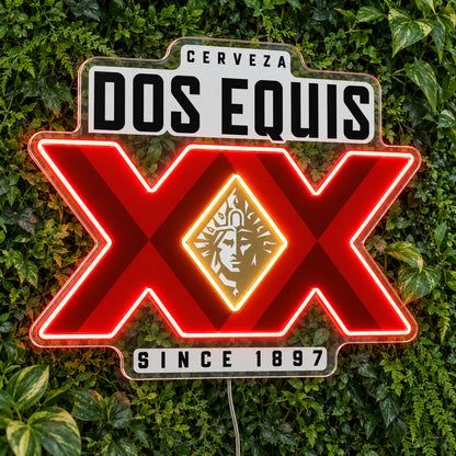 Dos Equis LED Neon Sign, featuring illuminated beer-brand logo on a green foliage wall.