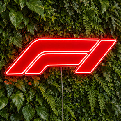 F1 (Formula One) LED Neon Sign in red, featuring Formula One logo against green foliage.