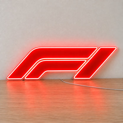 F1 (Formula One) LED Neon Sign in red, featuring Formula One logo standing on a wooden surface.
