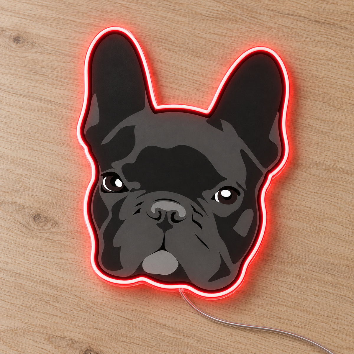 French Bulldog (Dark) LED Neon Sign in red, featuring a dark French bulldog face with a glowing outline on a wooden surface.