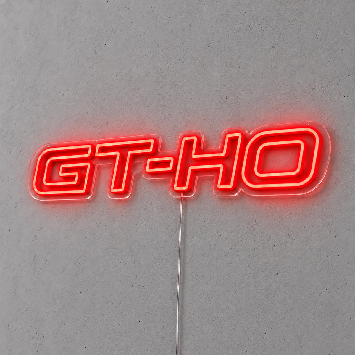 GT-HO LED Neon Sign in red, featuring GT-HO lettering on a grey wall.