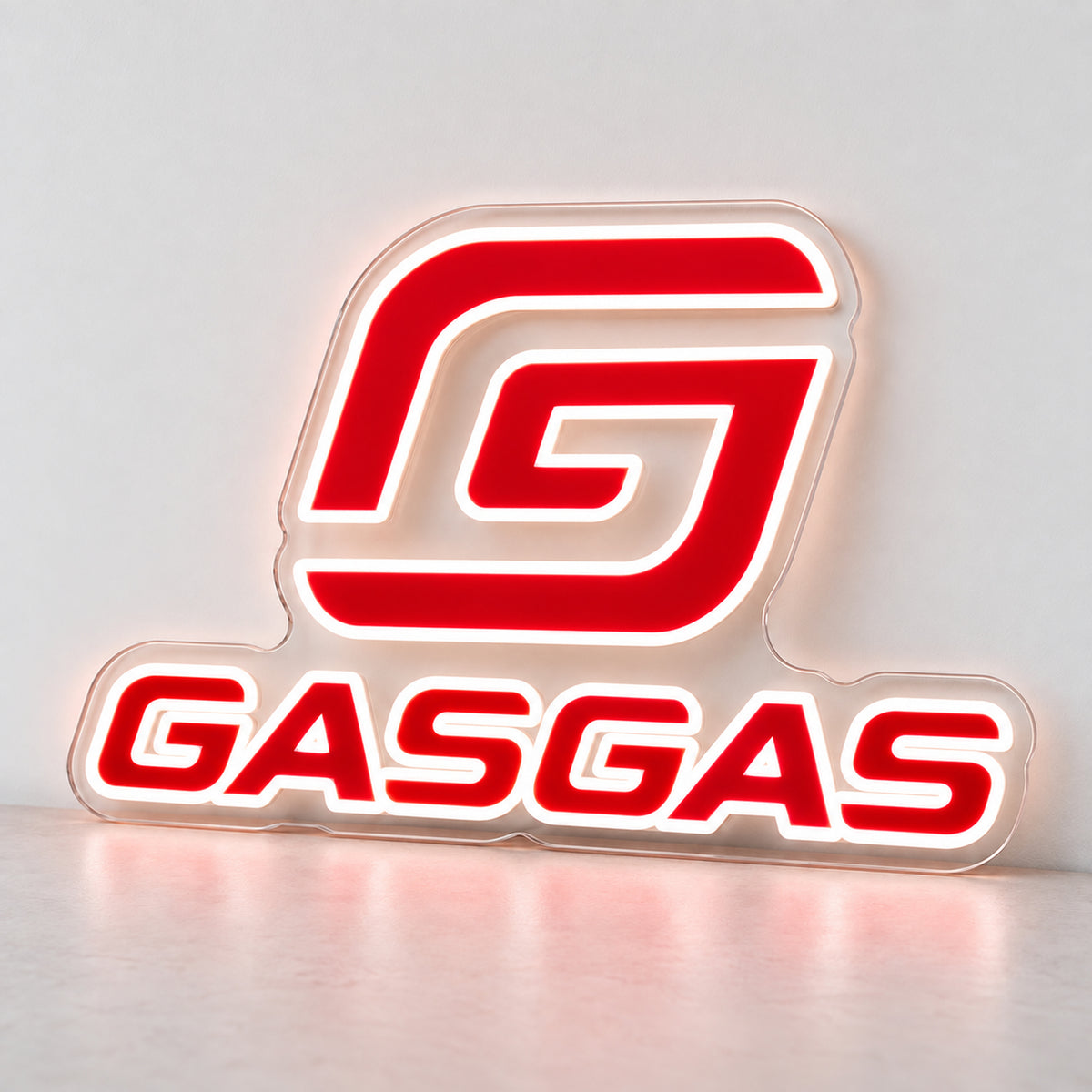 GasGas (Red) LED Neon Sign, featuring illuminated GasGas emblem and lettering standing on a light reflective surface.