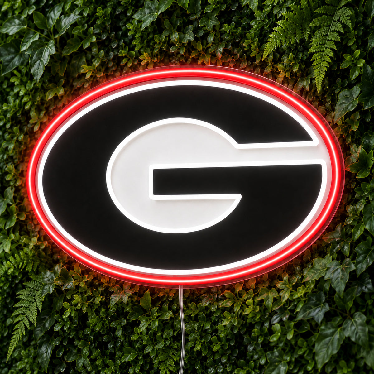 Georgia Bulldogs LED Neon Sign, featuring illuminated team logo on a green foliage wall.